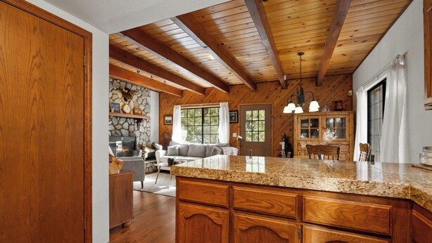 A spacious kitchen with wooden cabinets and a granite countertop. - Little Bear Lodge (Big Bear Lake)