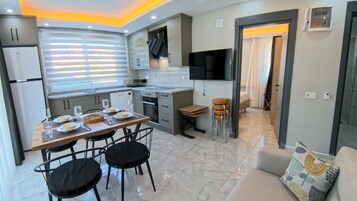 Deluxe Apartment, Kitchen, Poolside | Free cribs/infant beds, free WiFi, bed sheets