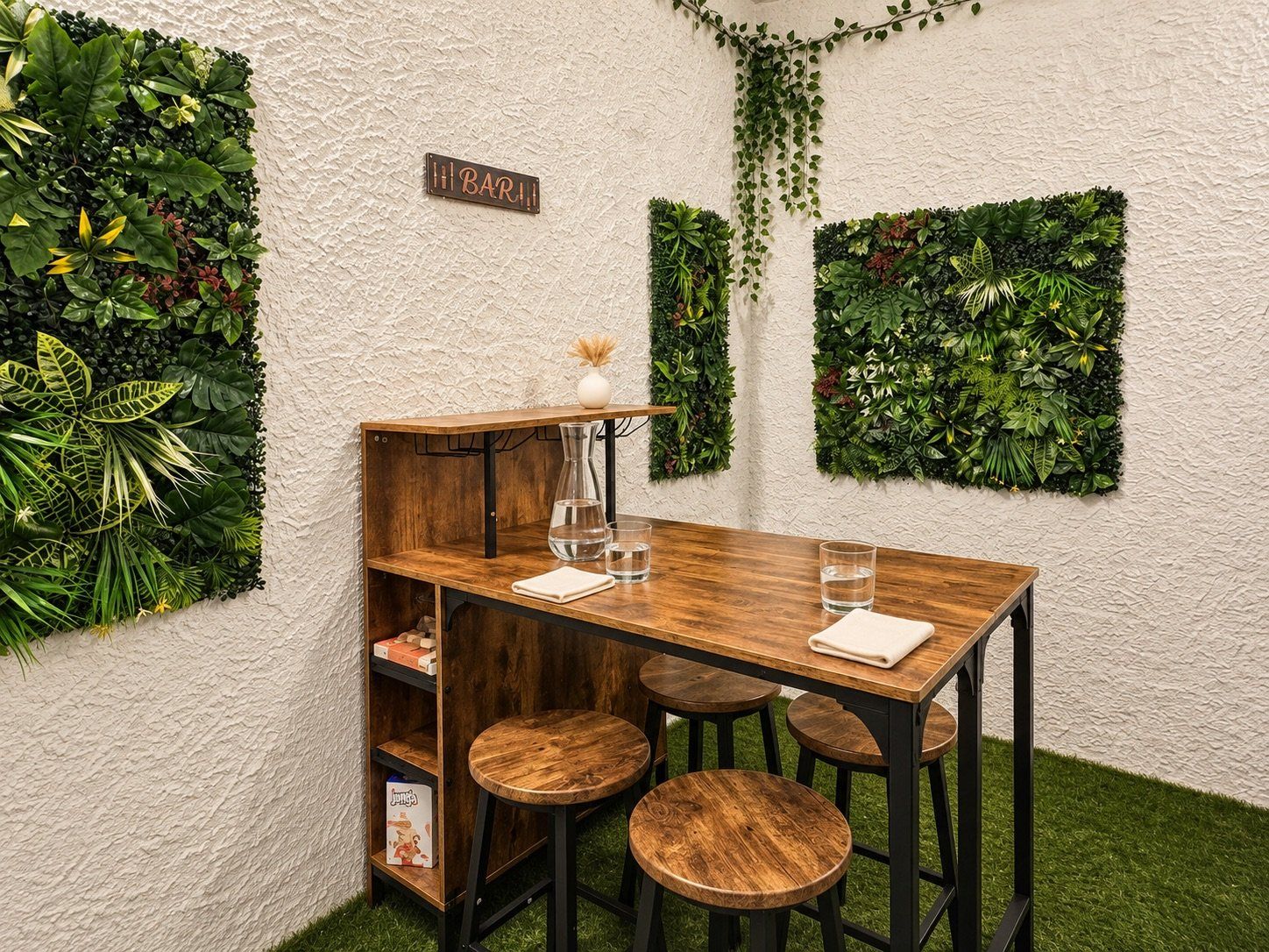 A wooden table with stools, a bar sign, and green wall decorations.