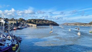 A marina with boats docked, a clear sky, and a hilly landscape in the background. - Morfach Charming Modern Cottage within Conwy walls (Morfach)