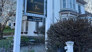 A Victorian-style building with a sign indicating a vacancy.