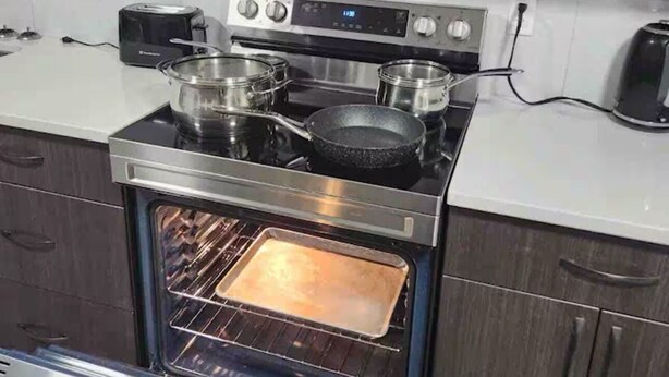 A kitchen with a stainless steel stove, oven, and microwave. - Modern, well furnished 1 bedroom home with free street parking (Spruce Grove)