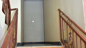 A wooden staircase with a handrail, leading to a door at the top. - The Urban Cabin Naivasha (Naivasha)