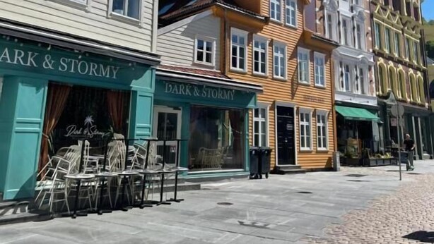 A row of historic buildings with storefronts, including 'Dark & Stormy'. - Bryggen Suites - Perfect Location (Bergen)