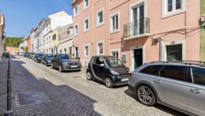 A street with parked cars and buildings.