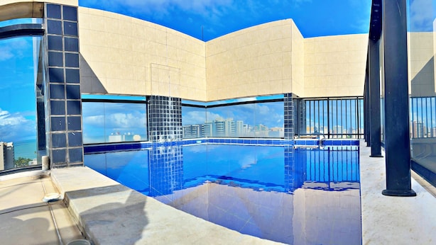 A modern building with a pool and a city view. - Vacation - edf. Barão de Mauá - 2 bedroom apt. 903, fully furnished in Jatiúca (Jatiúca Maceió)