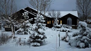 A snow-covered landscape with a large building featuring a prominent entrance and a lit interior. - Pet-Friendly Retreat w/ Fenced Yard & Fire Pit (Pagosa Springs)