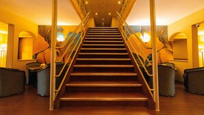 A staircase with metal railings and a wooden floor, leading to a higher level. - Aquamarina Hotel Visegrád (Visegrád)