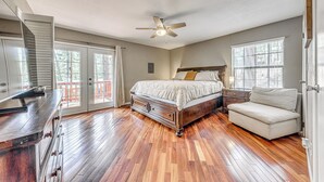 A bedroom with a bed, a nightstand, a chair, a dresser, and a ceiling fan. - 1 Block to Hiking: Ruidoso Home w/ Game Room (Ruidoso)