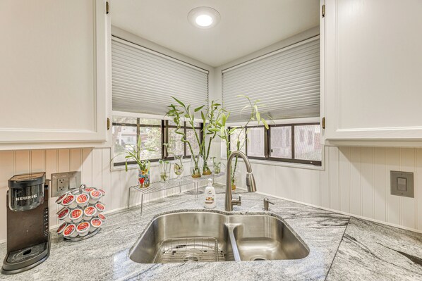 A kitchen with a built-in coffee maker, a sink, and a window with blinds. - Mesa Haven w/ Patio, Heated Pool & Hot Tub Access (Mesa)