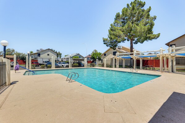 A swimming pool with a clear blue water, surrounded by a concrete deck, and a fence. - Mesa Haven w/ Patio, Heated Pool & Hot Tub Access (Mesa)
