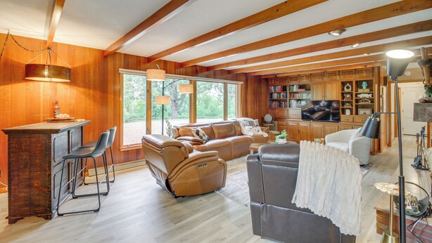 A spacious living area with a wooden ceiling, a sofa, a recliner, and a bar area with chairs. - 11 Mi to Maple Lake: 5-Acre Property in Fertile! (Fertile)