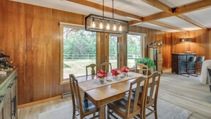 A wooden-paneled dining room with a large table, chairs, and a hanging light fixture. - 11 Mi to Maple Lake: 5-Acre Property in Fertile! (Fertile)