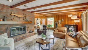 A spacious living room with a fireplace, leather sofas, and wooden beams. - 11 Mi to Maple Lake: 5-Acre Property in Fertile! (Fertile)