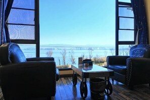 A room with a view of a bridge, a table with a chair, and a window with curtains. - Dali Zouzou Tingting Seaview Inn (Dali City)