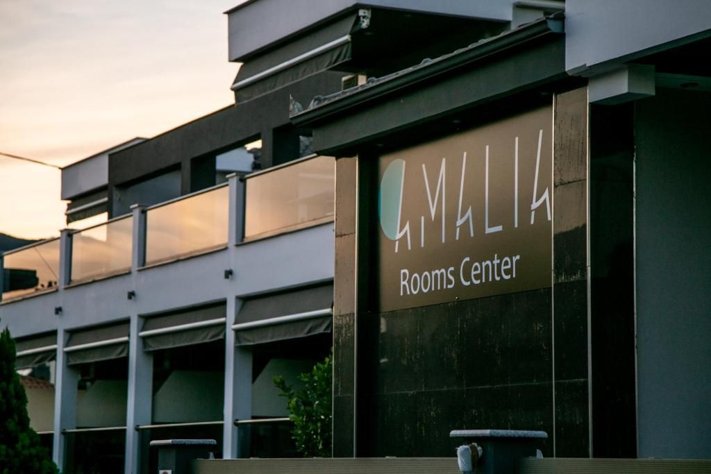 Ein Gebäude mit einem Schild, auf dem 'MALIA Rooms Center' steht.