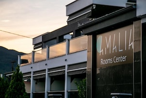 A building with a sign that reads "MALIA Rooms Center."