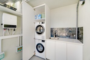 A compact laundry area with a washing machine, dryer, and a small sink. - Suite Pescado Salado 7 with Shared Terrace and Wi-Fi (Santa Cruz)