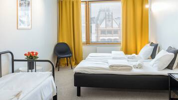 Premium bedding, desk, laptop workspace, blackout drapes