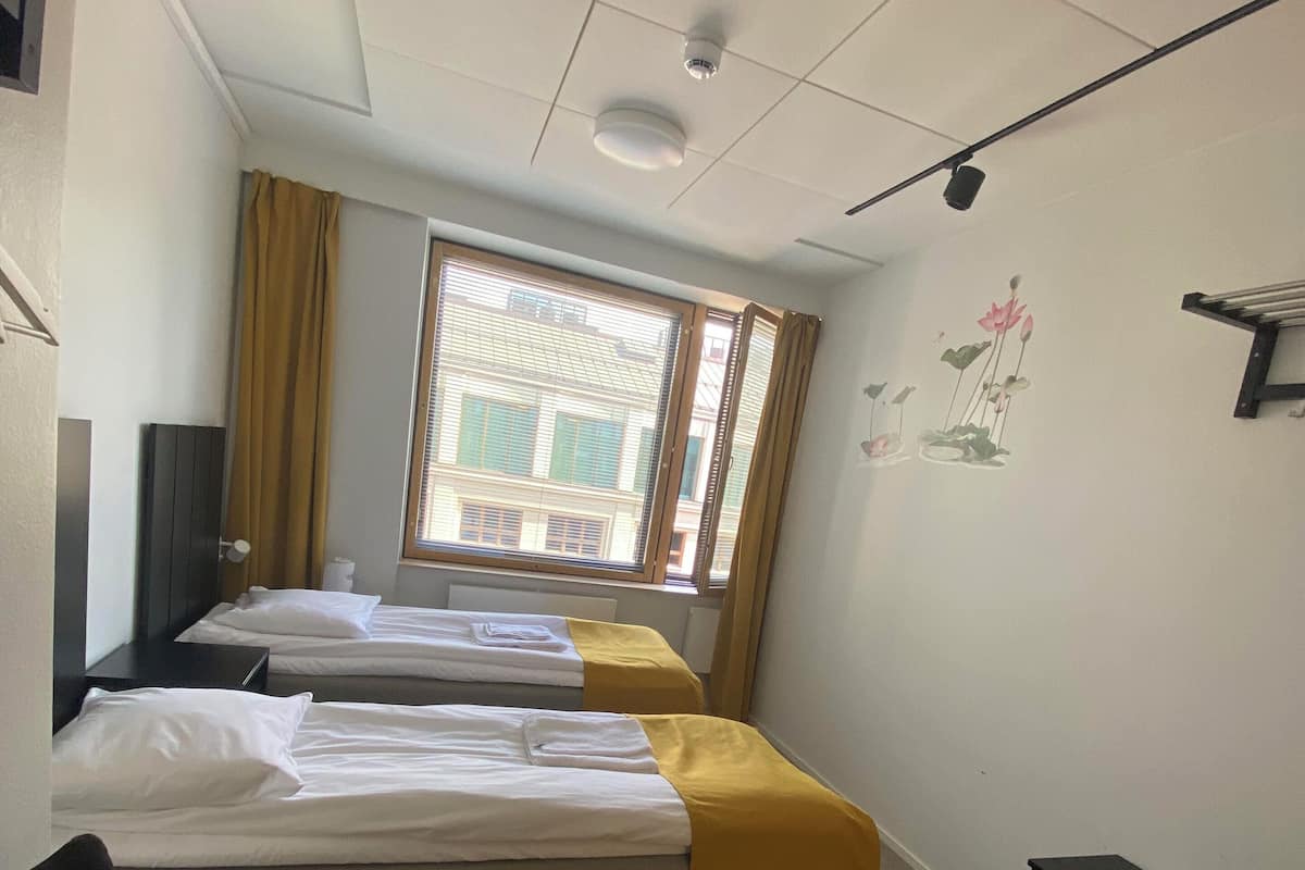Premium bedding, desk, laptop workspace, blackout drapes