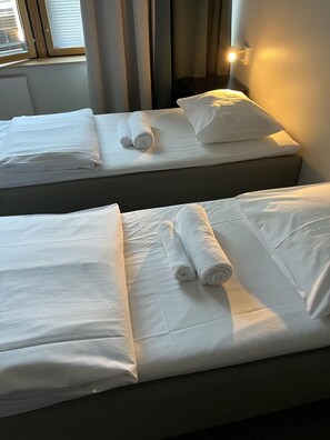 Premium bedding, desk, laptop workspace, blackout drapes