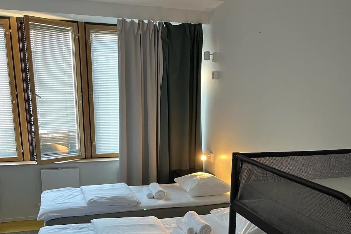 Premium bedding, desk, laptop workspace, blackout drapes