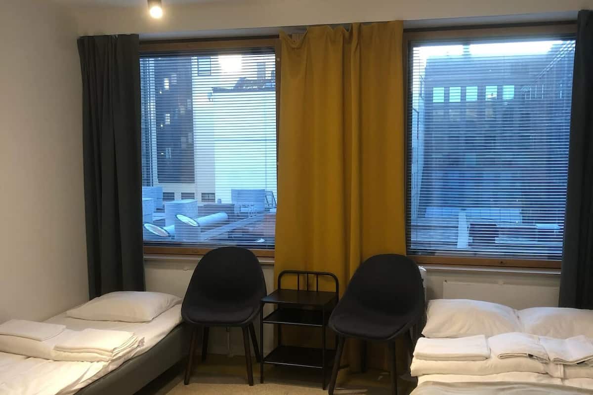Premium bedding, desk, laptop workspace, blackout drapes