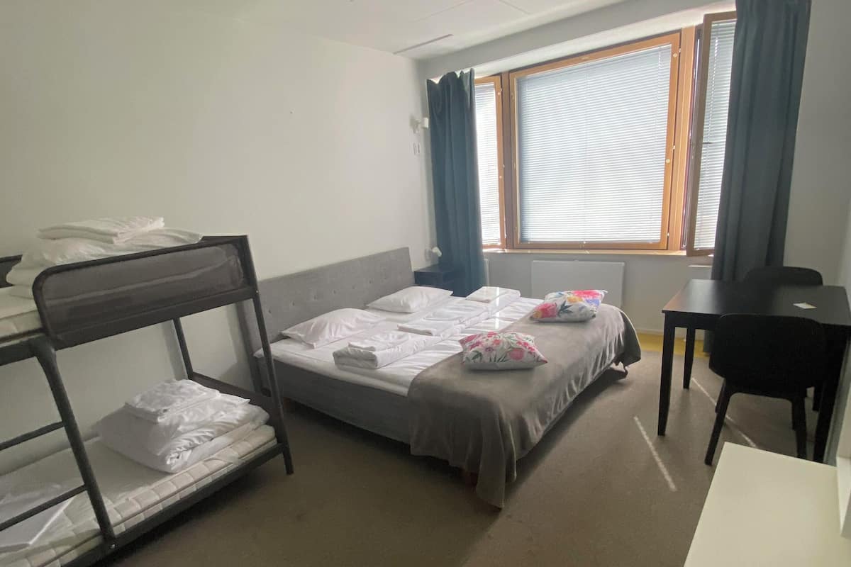Premium bedding, desk, laptop workspace, blackout drapes