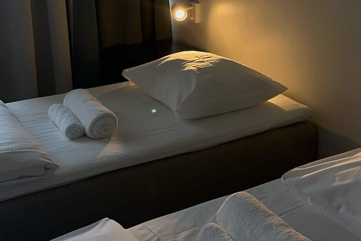 Premium bedding, desk, laptop workspace, blackout drapes