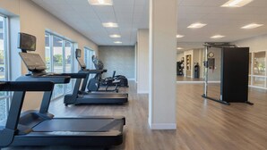 A modern gym with treadmills, exercise bikes, and a weight area. - Towneplace Suites By Marriott Dayton Beavercreek (Beavercreek)