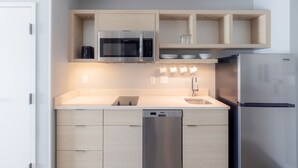 A modern kitchen with built-in appliances, including a dishwasher, microwave, and refrigerator. - Towneplace Suites By Marriott Dayton Beavercreek (Beavercreek)