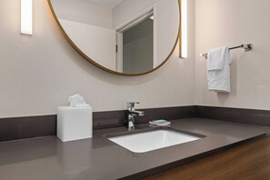 A modern bathroom with a large mirror, a white sink, a towel rack, and a tissue box. - Fairfield By Marriott Inn & Suites Dixon (Dixon)