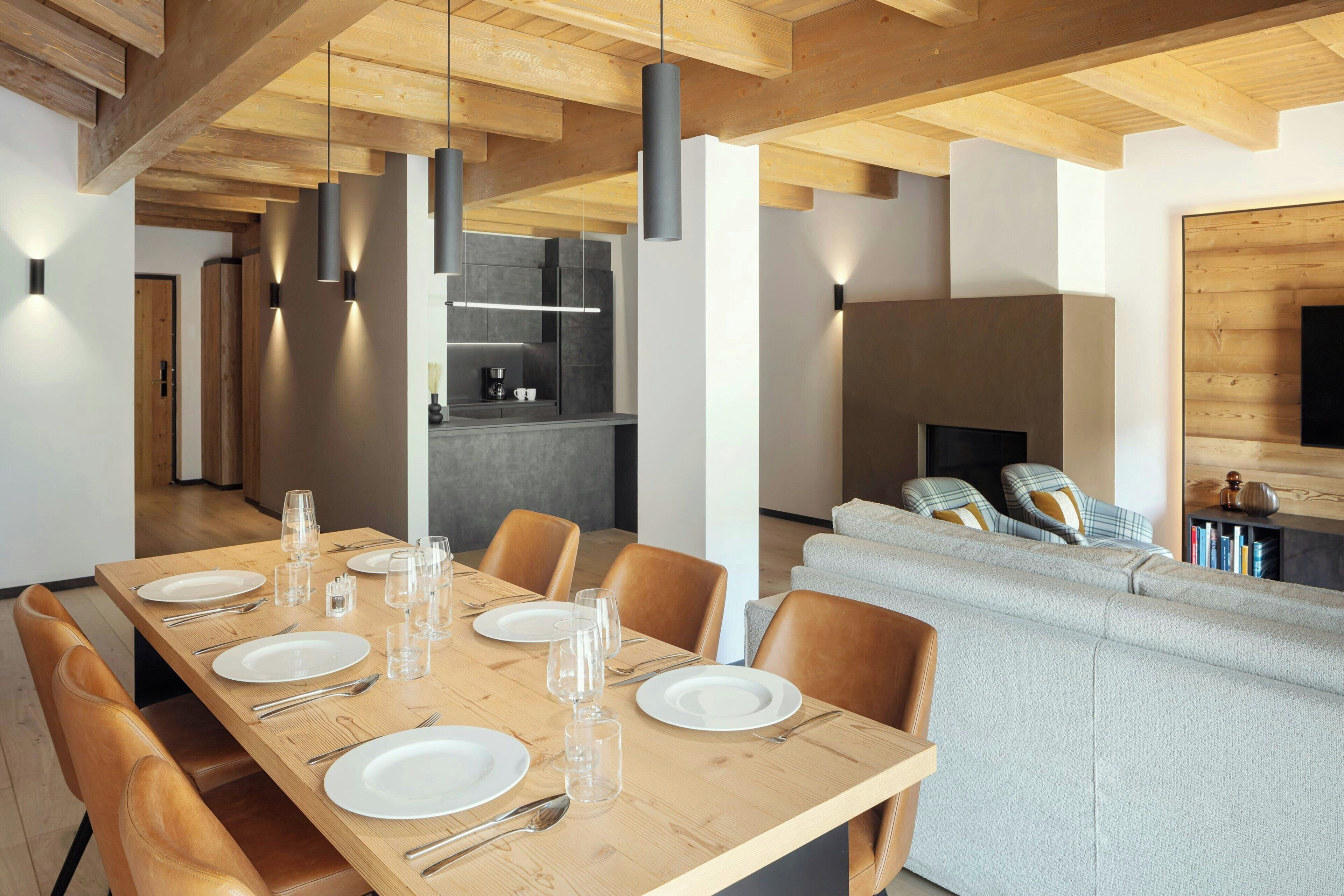 A modern interior with a dining area, kitchen, and living space.