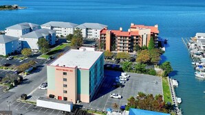 A coastal hotel with multiple buildings, a marina, and a parking lot.