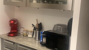 A modern kitchen with stainless steel appliances, a coffee maker, and various utensils on the countertop. - Quiet house in Vernon (Vernon)