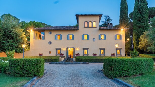A large, two-story building with a symmetrical facade, multiple windows, and a central entrance with steps. - Villa Loretino - Ultimate Luxury in Florence (Comeana)