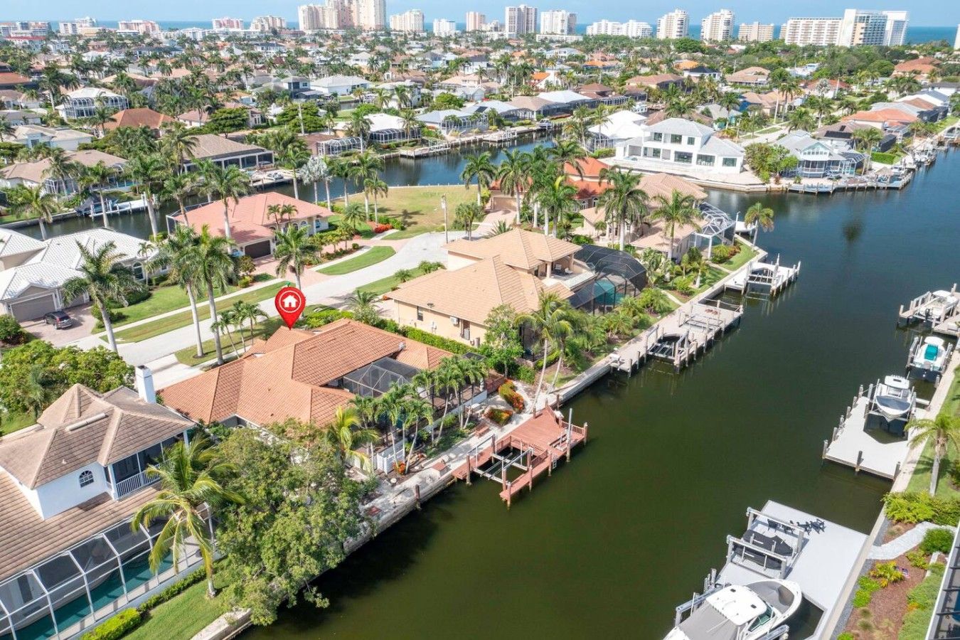 A residential area with a marina, houses, and a body of water.