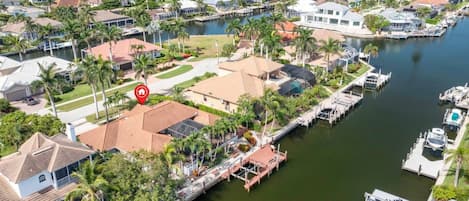 A residential area with a marina, houses, and a body of water.