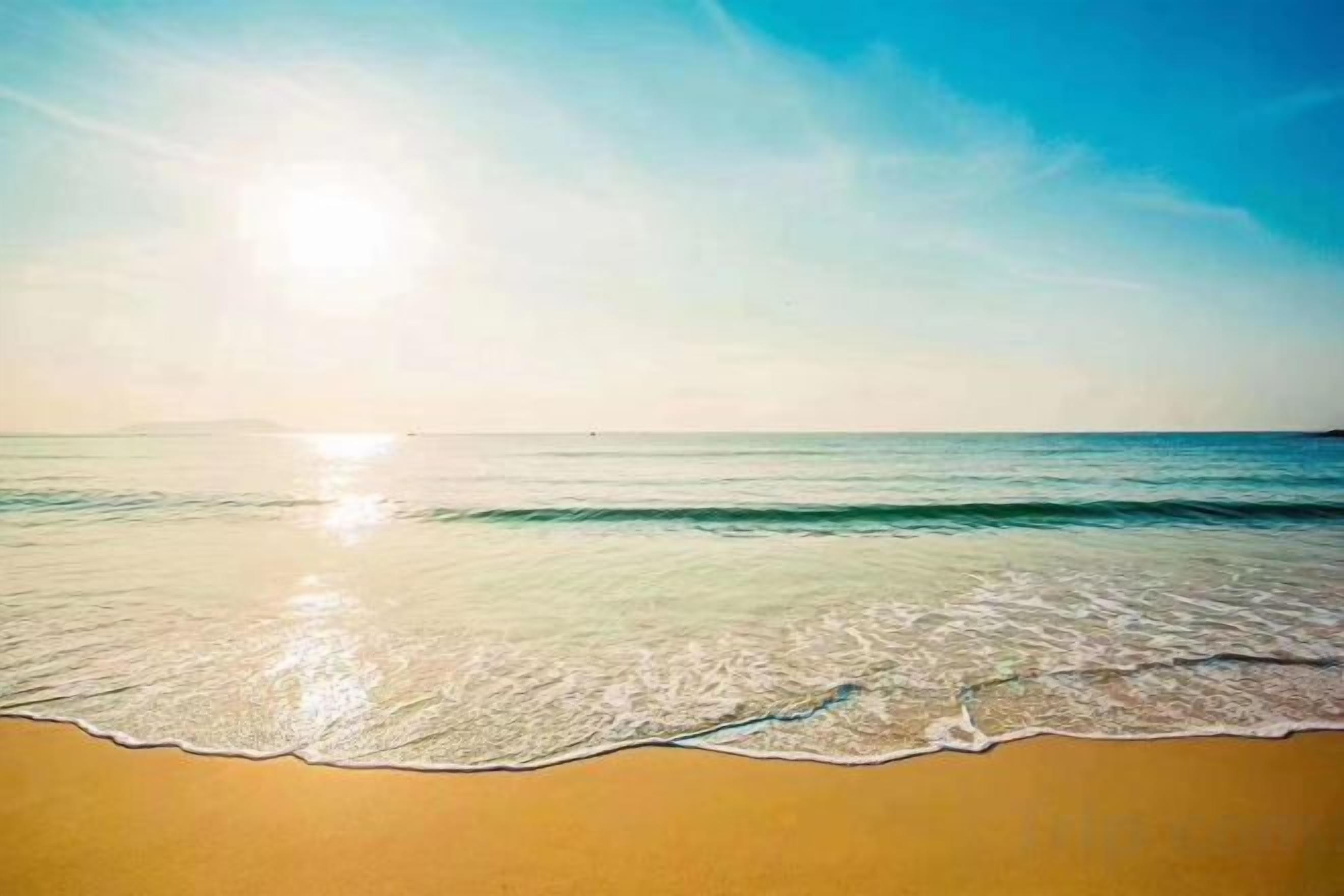 A beach with clear skies and calm waters.