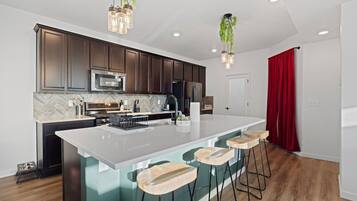 Fridge, toaster, blender, dining tables