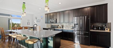 Fridge, toaster, blender, dining tables