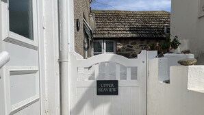 A white gate with a sign reading "UPPER SEAVIEW."