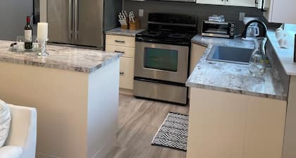 New 2 bedroom suite with private parking and entrance steps away from beach