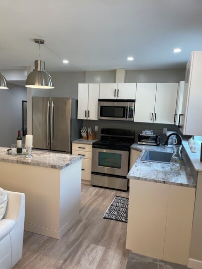 New 2 bedroom suite with private parking and entrance steps away from beach