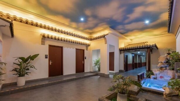 A hotel lobby with a ceiling mural, tiled flooring, and potted plants. - No.1 Boutique Hotel (Changshu Qinhu Branch) (Changshu)