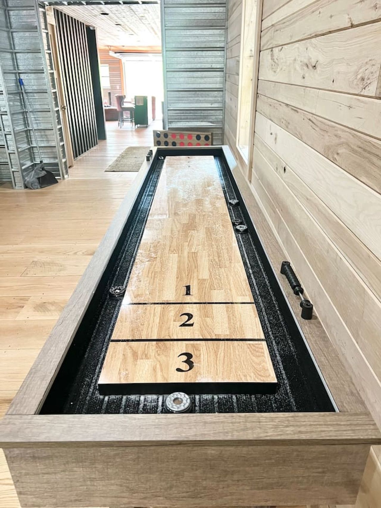 A shuffleboard table with numbered scoring areas.