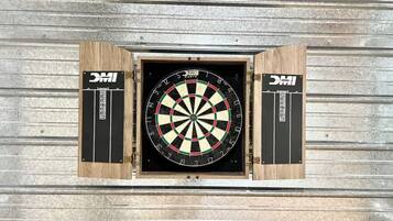 A dartboard mounted on a wall with a wooden frame.