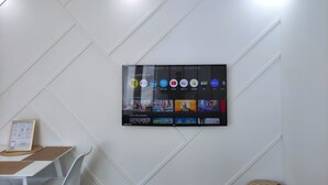 A wall-mounted TV displaying various streaming apps and popular series. - CinéLux - Private Experience [Full accomodation] [Full accomodation (Algrange)