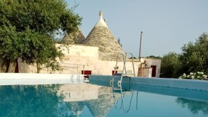 A swimming pool with a stone building in the background.