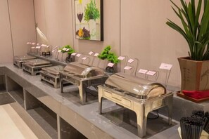 A buffet setup with multiple serving stations, each with a sign indicating the type of food available. - Dinis Hotel (Luoyang Kaiyuan) (Luoyang)